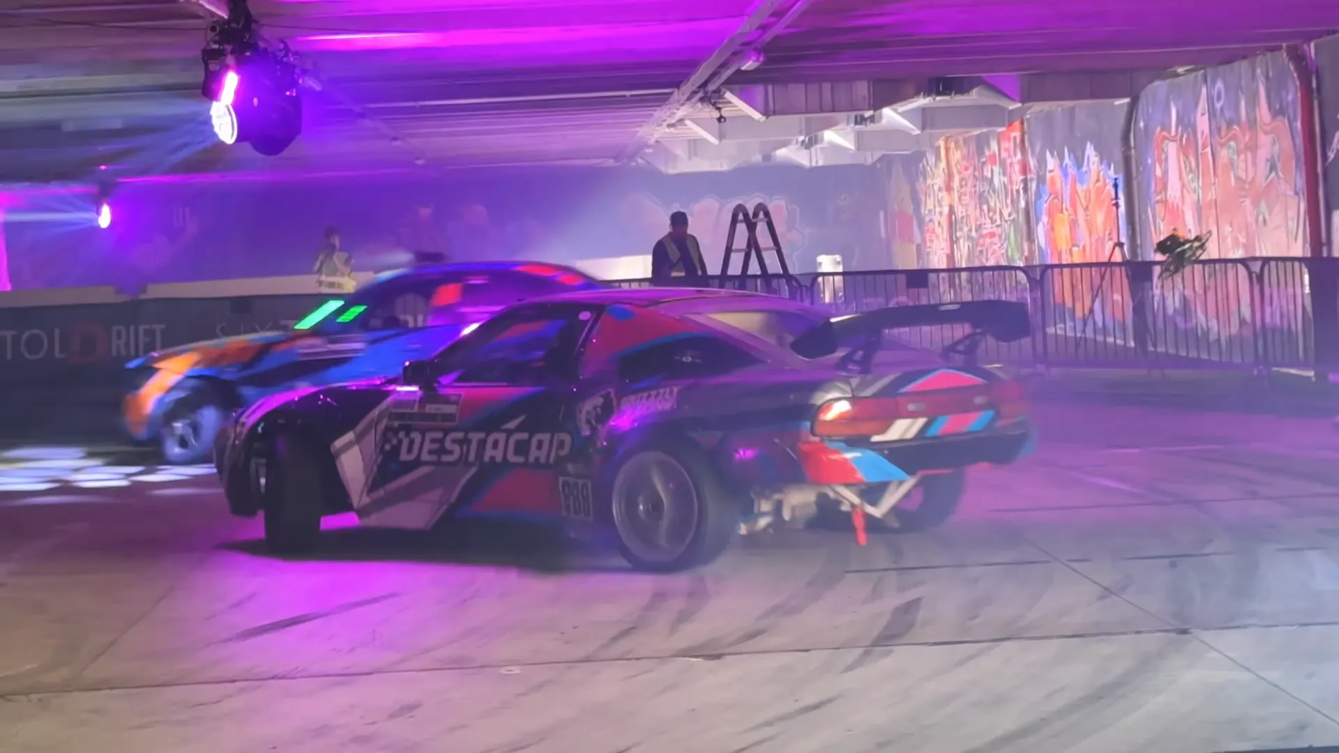 Destacar drift car number 888 in a tandem battle in the underground car park in Liberec