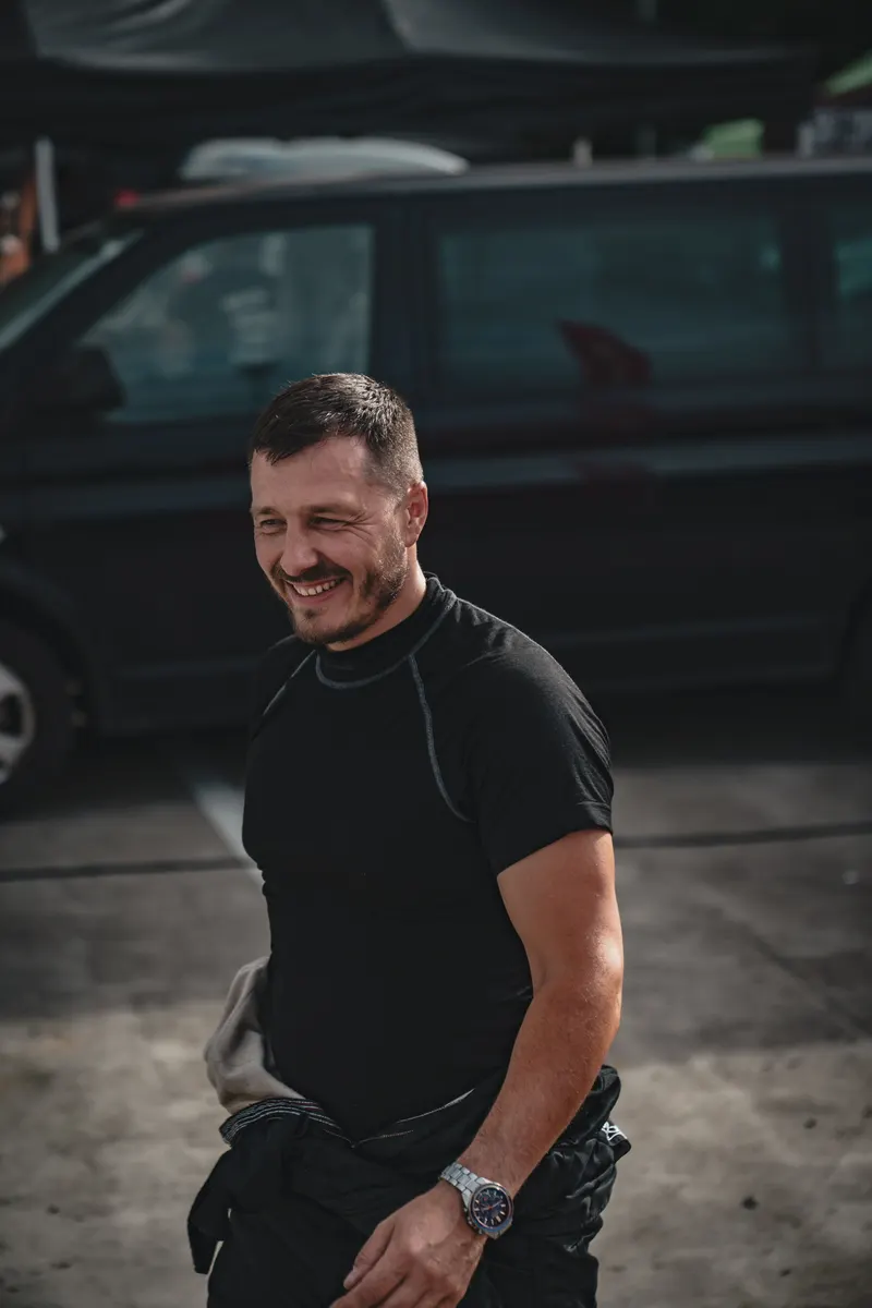 Denis Rem laughing in the paddock between runs