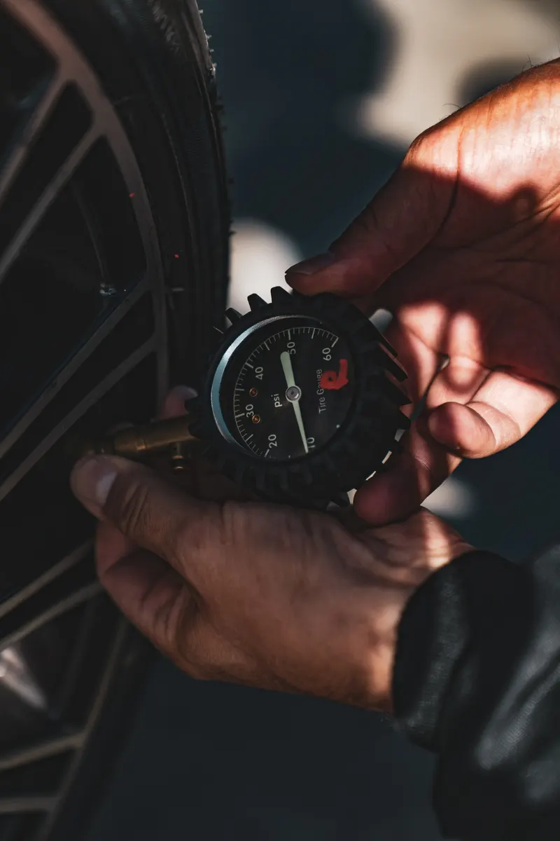 Pressure gauge in hand at the wheel of a drift car